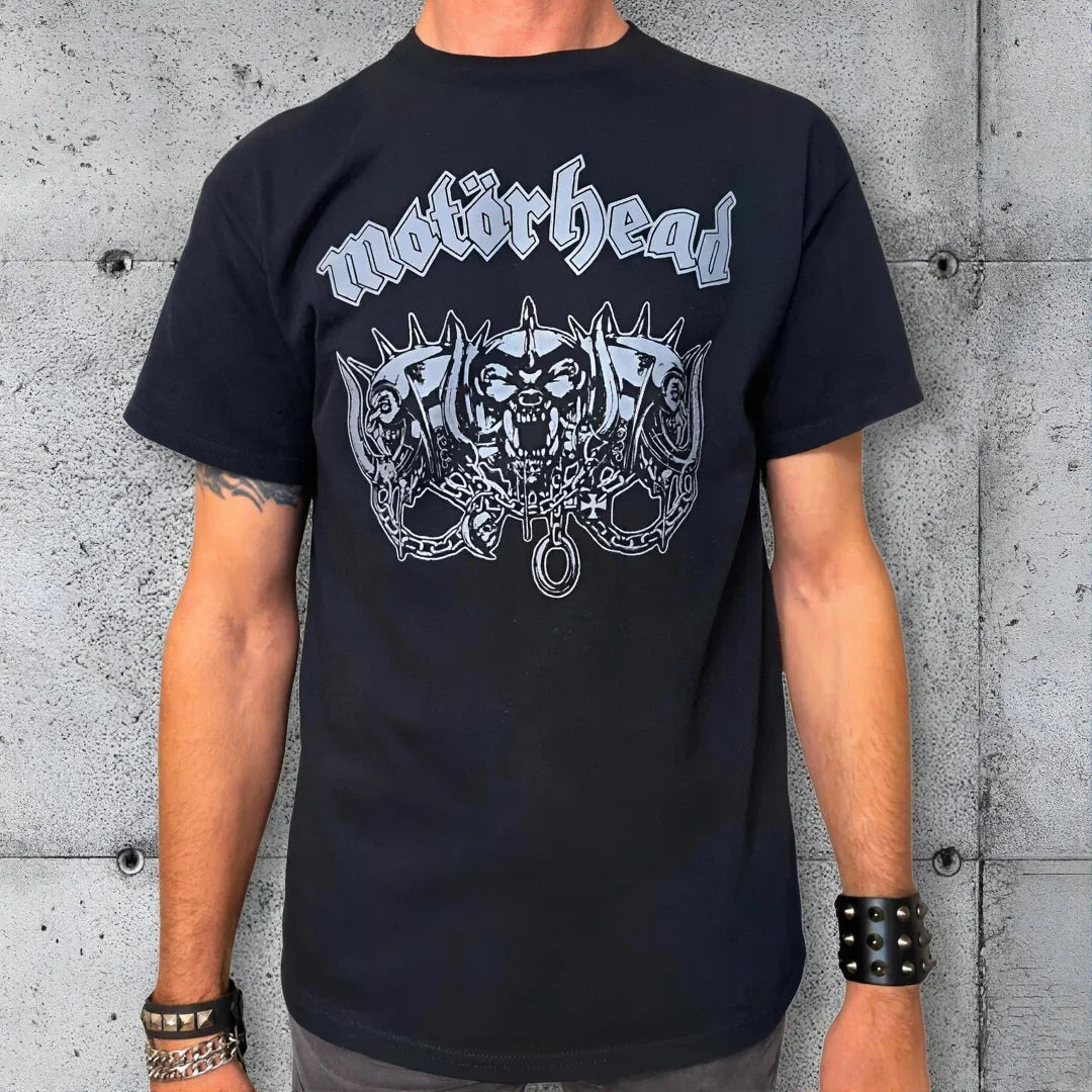 Man wearing black Motörhead three-headed Warpig punk rock graphic t-shirt against concrete wall