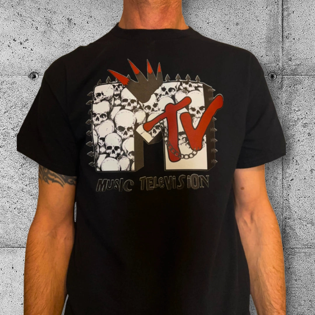 Black punk MTV T-shirt with skull graphic, rocker clothing style, concrete background