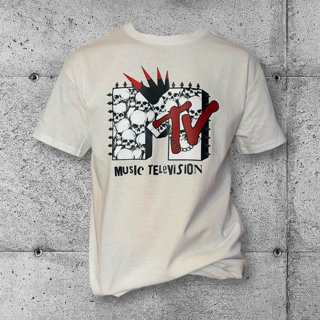White punk MTV graphic tee with skulls and spikes, rocker gothic fashion, concrete background