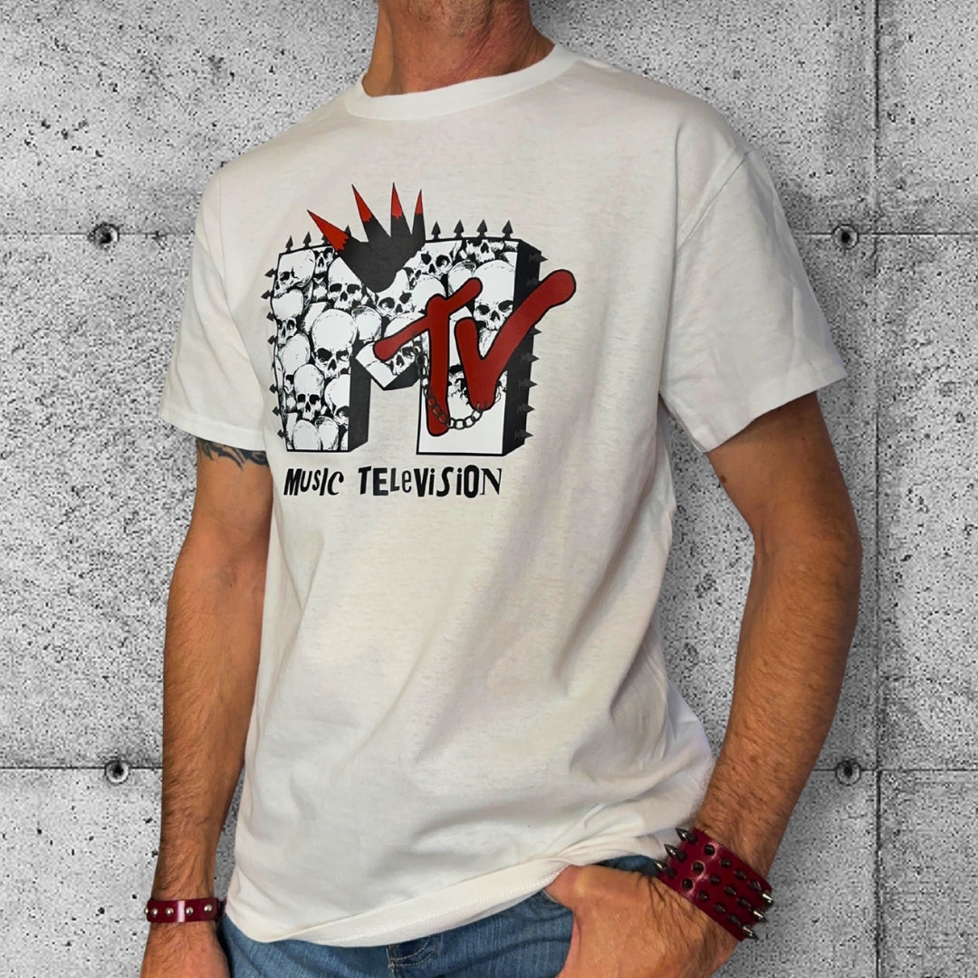 Man wearing punk MTV skull logo t-shirt with spiked bracelets, rocker clothing style