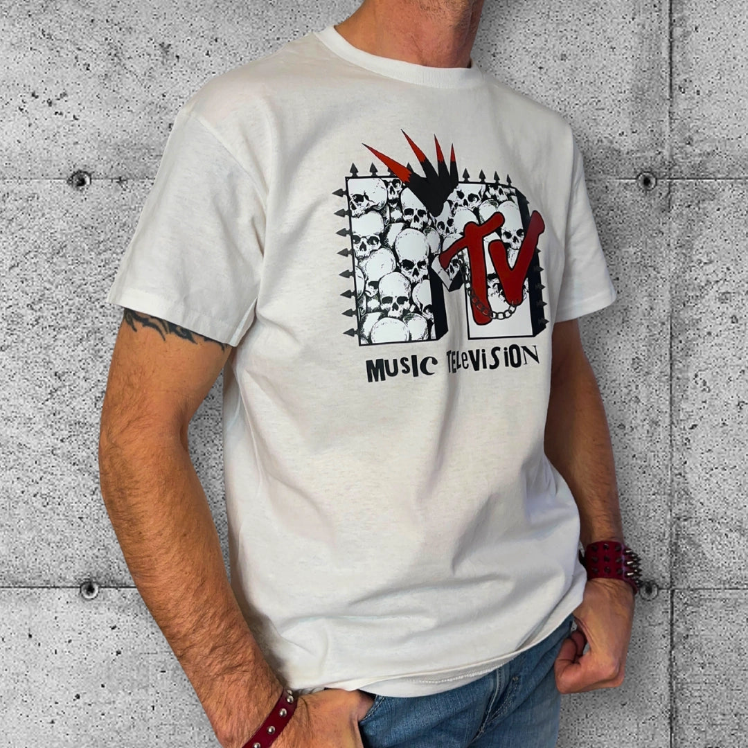Man wearing white punk MTV T-shirt with skull and spike design, edgy rocker fashion style