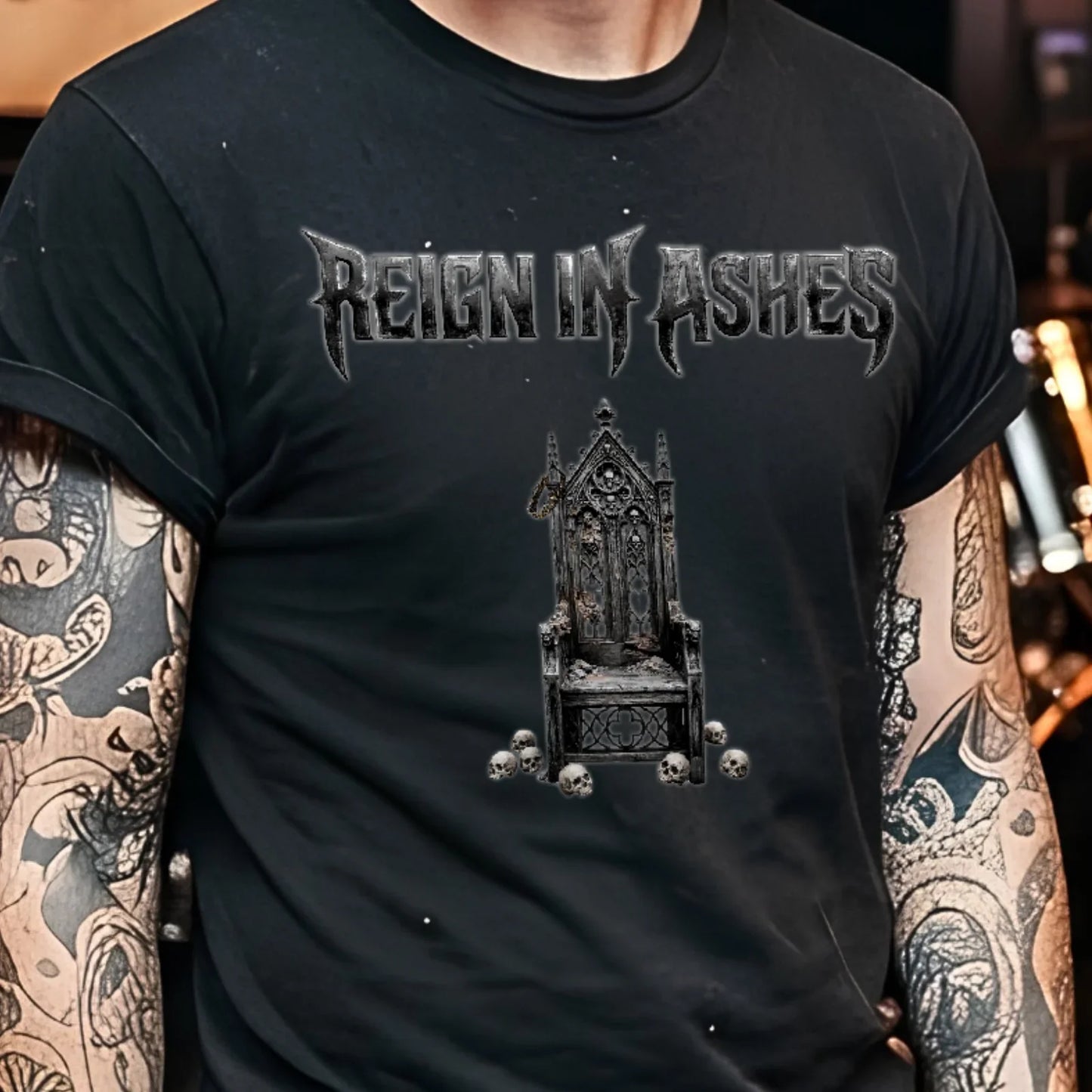 Black punk t-shirt with 'Reign in Ashes' gothic throne graphic, skulls, worn by tattooed person