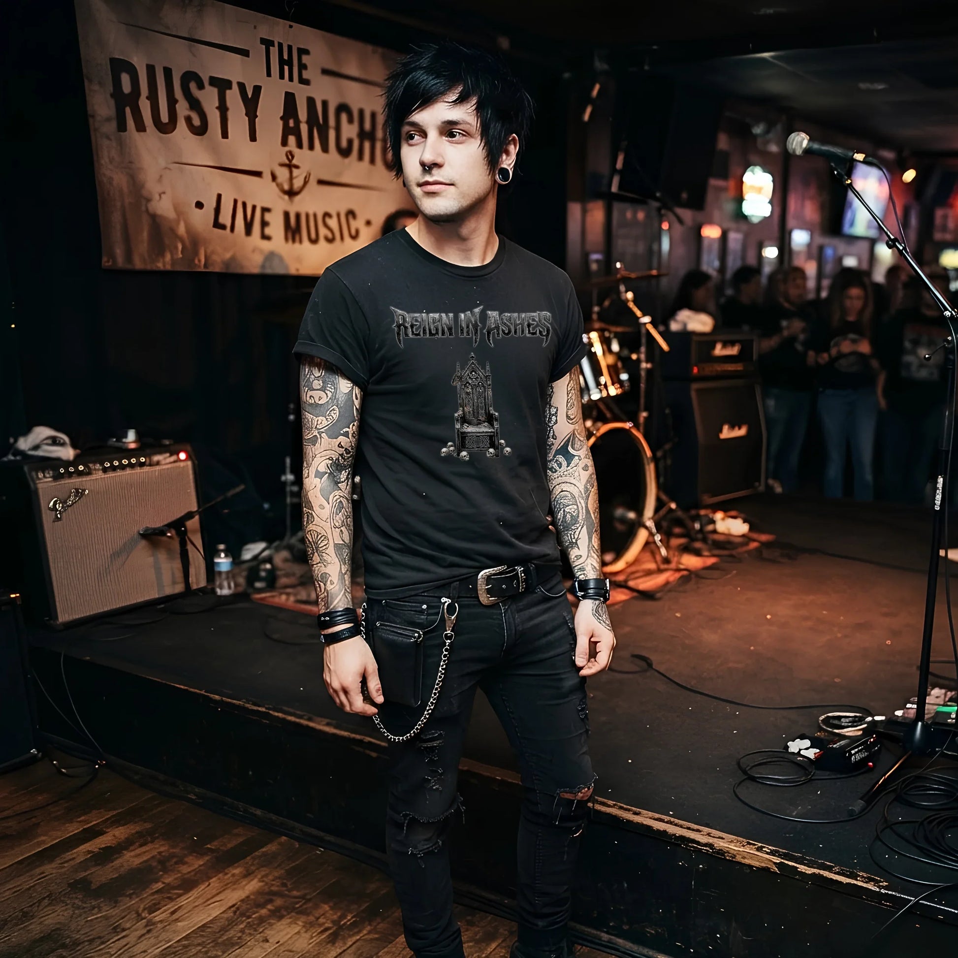Man in punk rock t-shirt and ripped jeans on stage, tattoos visible, gothic band graphic