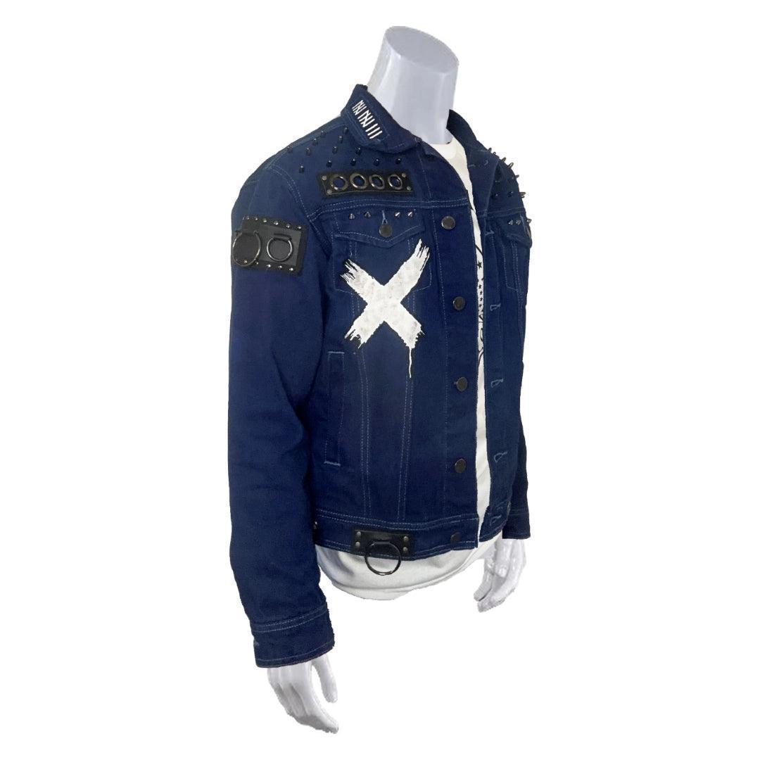 Right side view of a royal blue denim punk-inspired jacket featuring black leather studded accent patch with metal o rings attached on right side arm.