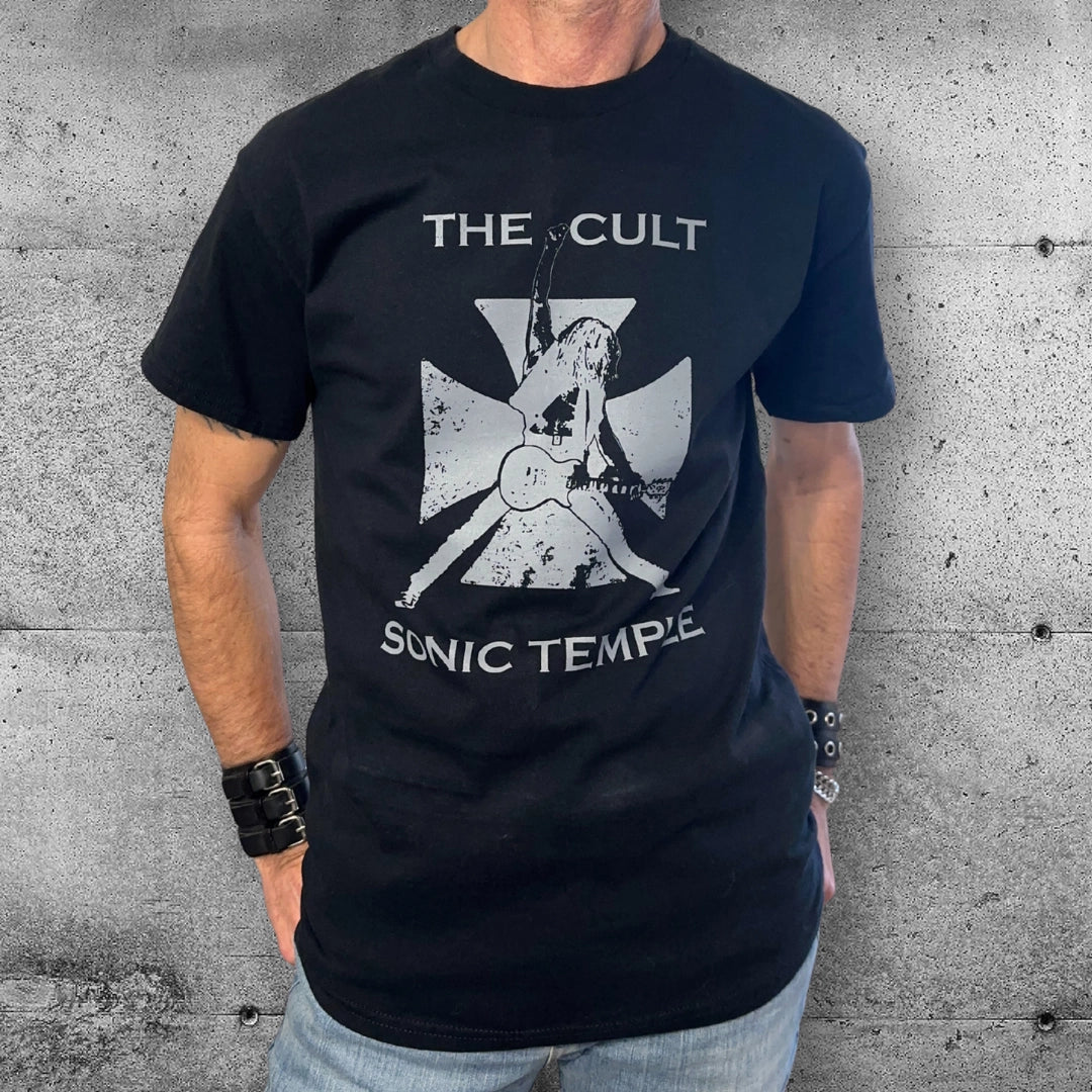 Man wearing The Cult Sonic Temple black punk rock t-shirt, gray concrete wall background
