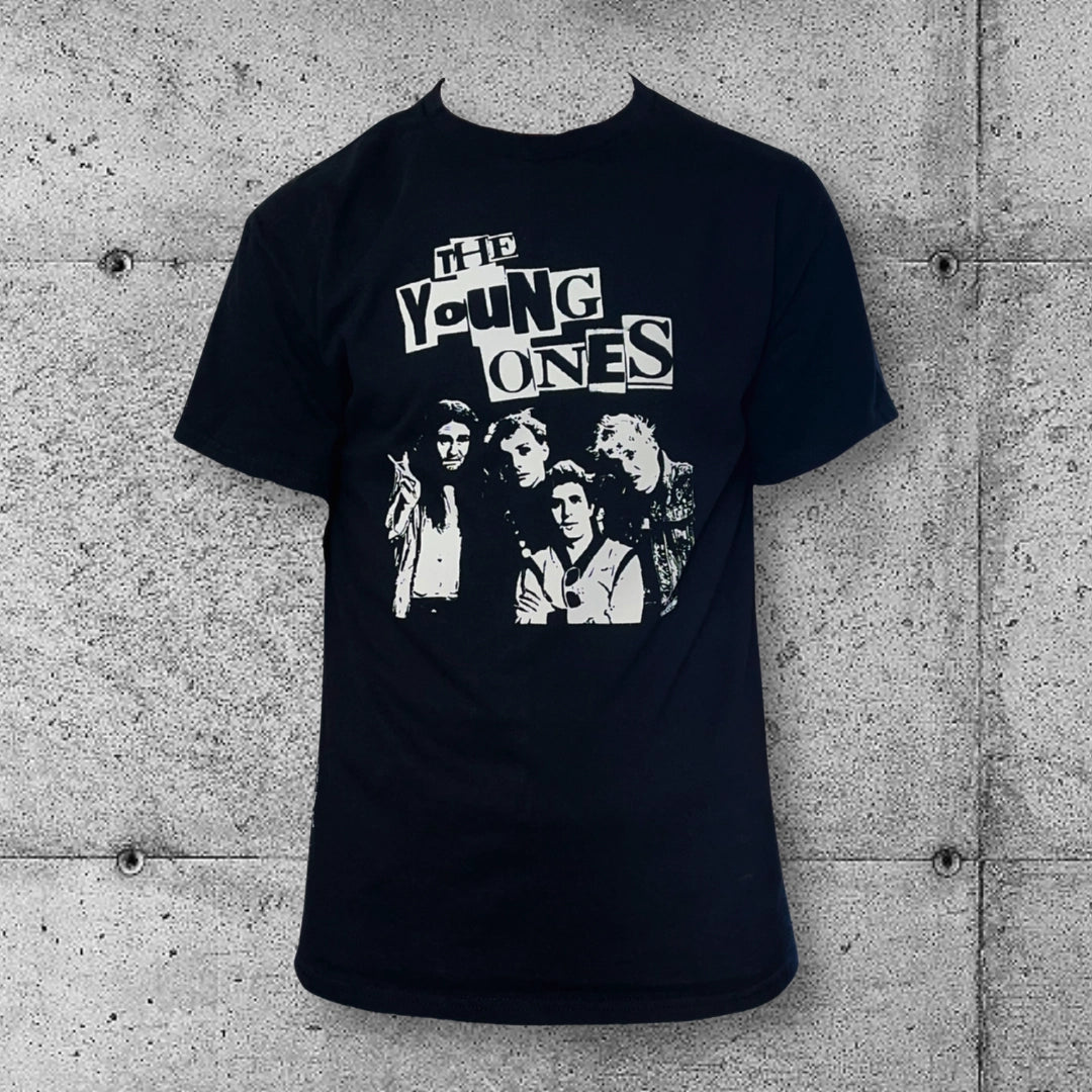 The Young Ones punk band T-shirt in black with white graphic and text, concrete wall background