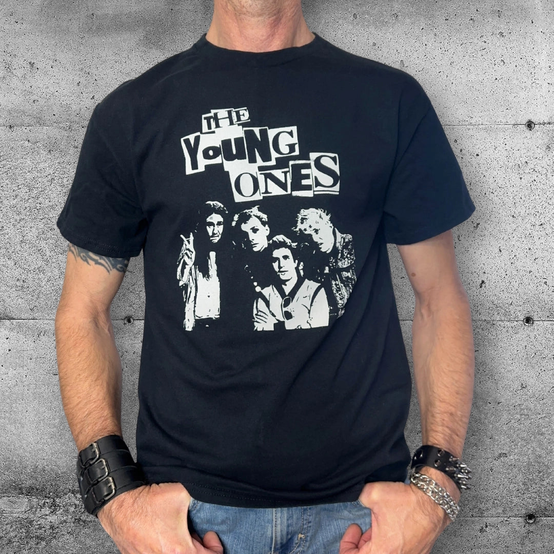 Man wearing punk rocker The Young Ones graphic t-shirt against concrete wall